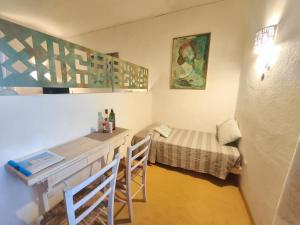 a small room with a desk and a bed at palazzo beddoro charming apartments in San Pantaleo +65 photos
