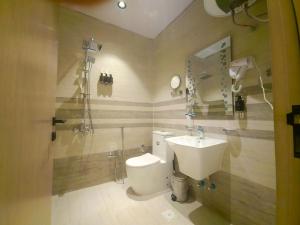 a bathroom with a sink and a toilet and a mirror at النخبة الرفيعة للشقق المخدومة in Al Qurayyat +22 photos