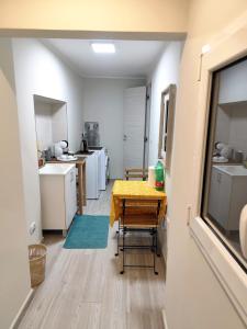 a kitchen with a table with a yellow table cloth on it at Due Delfini in Taranto