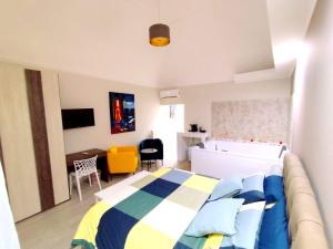 a bedroom with a bed and a couch and a desk at Due Delfini in Taranto