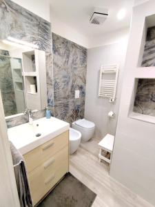 a bathroom with a sink and a toilet in it at Due Delfini in Taranto +11 photos