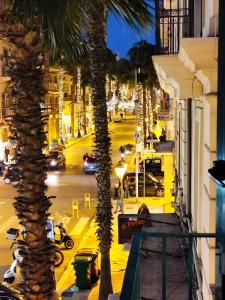 a palm tree on a city street at night at Due Delfini in Taranto