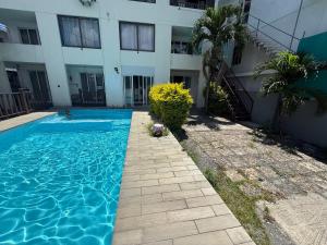 a swimming pool in front of a building at Din villa in Cap Malheureux