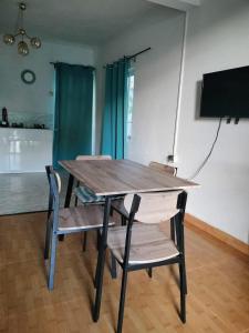 a wooden table and chairs in a room at Din villa in Cap Malheureux