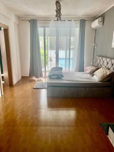 a bedroom with a large bed and a large window at Din villa in Cap Malheureux +2 photos