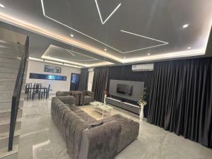 a living room with a couch and a television at Happy Home in Trofwi