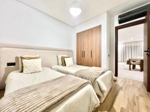 a bedroom with two beds and a sliding glass door at Marrakech golf City prestigia in Marrakesh +38 photos
