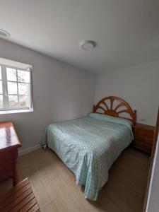 a bedroom with a bed and a window at A Casa do Río Bueu in Bueu +11 photos