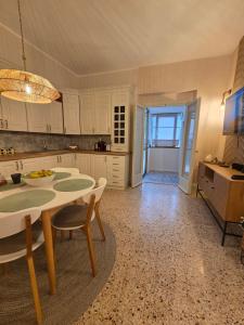 a kitchen with a table and chairs in a room at Casa Larissa in Rufina