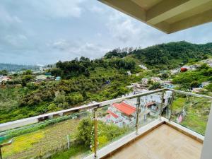 a balcony with a view of a mountain at Zioneliteresidency in Kodaikānāl