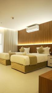two beds in a hotel room with at فندق روزز إس in Riyadh +100 photos