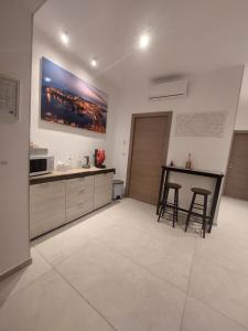 a kitchen with a table and two stools at La Pilozza Guest Rooms in Gallipoli