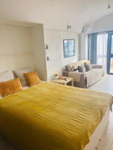 a large yellow bed in a room with a couch at Golfe de Saint Tropez Terrasses de Sylvabelle Gigaro in La Croix-Valmer +87 photos
