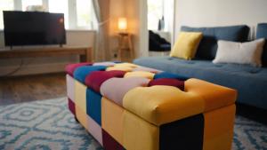 a colorful couch sitting in a living room at 2 Bridge View in Selby