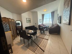 a living room with a couch and a table and chairs at Your Comfort Starts Here in Ras al Khaimah