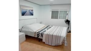 a bedroom with a bed with a white comforter at Villa entre terre et mer in Montroy +7 photos