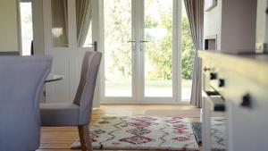 a room with a table and a chair and a door at 2 Bridge View in Selby +15 photos