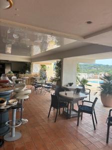 a restaurant with tables and chairs and a patio at Golfe de Saint Tropez Terrasses de Sylvabelle Gigaro in La Croix-Valmer