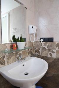 a bathroom with a white sink and a mirror at Mahaweli Haven in Nattarampota +101 photos