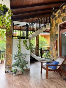 a living room with a spiral staircase in a house at Mahaweli Haven in Nattarampota