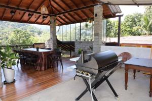 a grill on a patio with a table and chairs at Mahaweli Haven in Nattarampota
