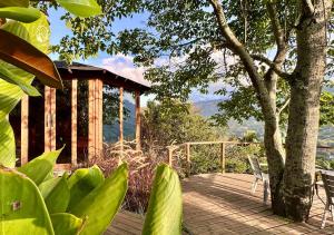 a wooden deck with a bench and a building at Finca Hotel Tierra Verde in Girardota