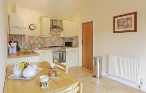 a kitchen with a table and a counter top at 1 Bed in Beccles oc-hfs in Wangford