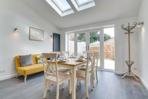 a dining room with a table and chairs and a couch at 3 Bed in Woodbridge oc-30mor in Woodbridge