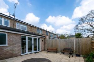 a backyard with a wooden fence and a bench at 3 Bed in Woodbridge oc-30mor in Woodbridge