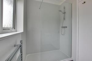 a shower with a glass door in a bathroom at 3 Bed in Woodbridge oc-30mor in Woodbridge +5 photos
