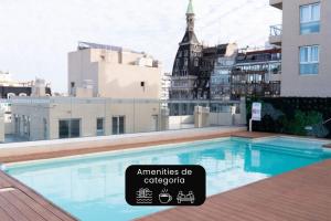 a swimming pool on the roof of a building at La Cisterna by DOT Suites in Buenos Aires