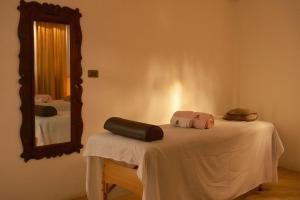 a room with a mirror and two beds with towels at Hotel Taa' Tiin in San Juan La Laguna