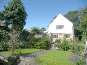 a white house with a garden in front of it at 2 Bed in Warkworth oc-nb319 in Warkworth