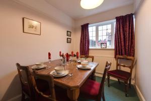 a dining room with a wooden table and chairs at 2 Bed in Warkworth oc-nb319 in Warkworth +3 photos