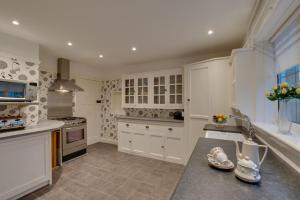 a kitchen with white cabinets and a counter top at 2 Bed in Warkworth oc-nb319 in Warkworth
