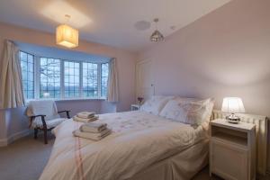 a bedroom with a white bed with towels on it at 2 Bed in Warkworth oc-nb319 in Warkworth