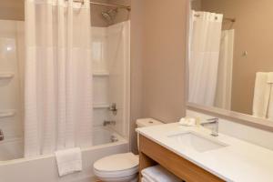 a bathroom with a sink and a toilet and a shower at LivAway Suites Phoenix Tolleson in Phoenix +19 photos