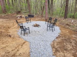 a group of chairs and a fire pit in the woods at Jack of Hearts in Rockbridge