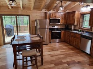 a kitchen with a table with chairs and a refrigerator at Jack of Hearts in Rockbridge