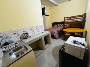 a kitchen with a sink and a couch in a room at Hospedaje San Cosme y Damián in Zarate Isla
