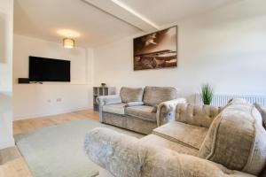 a living room with two couches and a flat screen tv at 2 Bed in Cromer oc-f28893 in Cromer