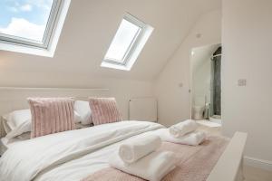 a bedroom with a large white bed with towels on it at 2 Bed in Cromer oc-f28893 in Cromer