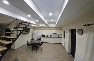 a kitchen and a dining room with a table and chairs at kazbegi - Sno Mountain House in Sno