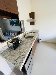 a kitchen with a sink and a counter top at Suites Santiago in Santiago