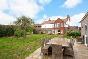 a patio with a table and chairs in front of a house at 6 Bed in Bacton oc-2316 in Bacton
