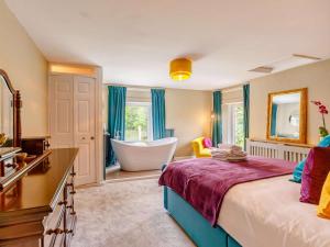 a bedroom with a bed and a bathroom with a bathtub at 5 Bed in Durham oc-85257 in Lanchester