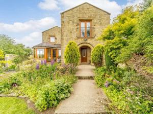 a stone house with a pathway leading to the front door at 5 Bed in Durham oc-85257 in Lanchester
