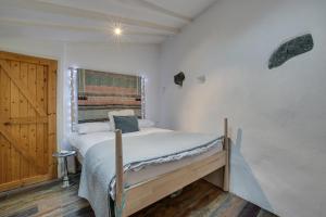 a bedroom with a bed and a wooden door at 1 Bed in St. Ives oc-drift4 in St Ives