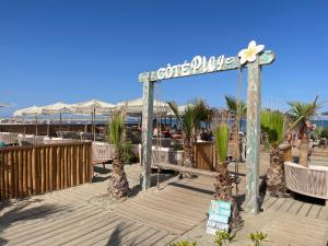a sign for a hotel on a beach with palm trees at Hôtel Paul Riquet in Béziers