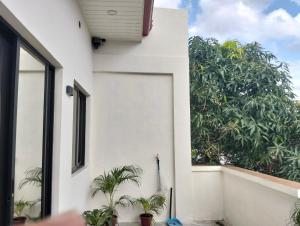 a white house with plants in front of it at Home stay in Pasig in Pasig